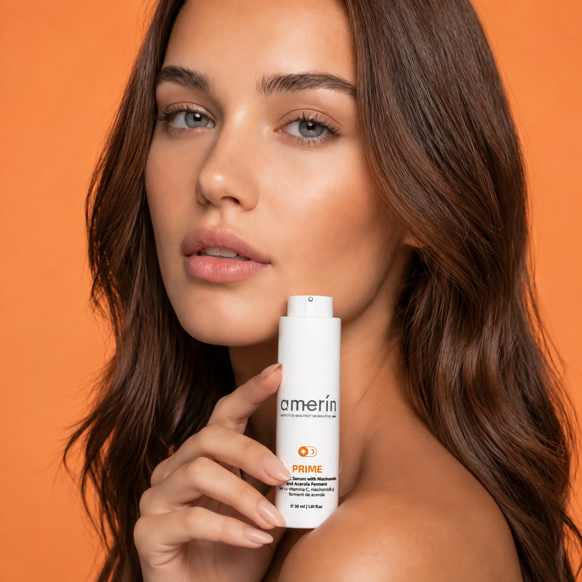 A woman with long brown hair holds a white Amerin PRIME skincare bottle against a solid orange background.